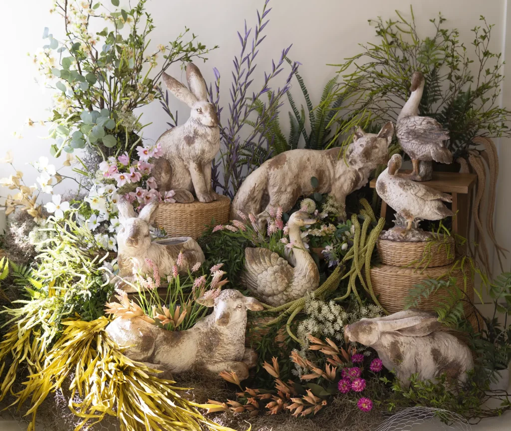 Faux concrete animal collection in a forest of botanica flowers