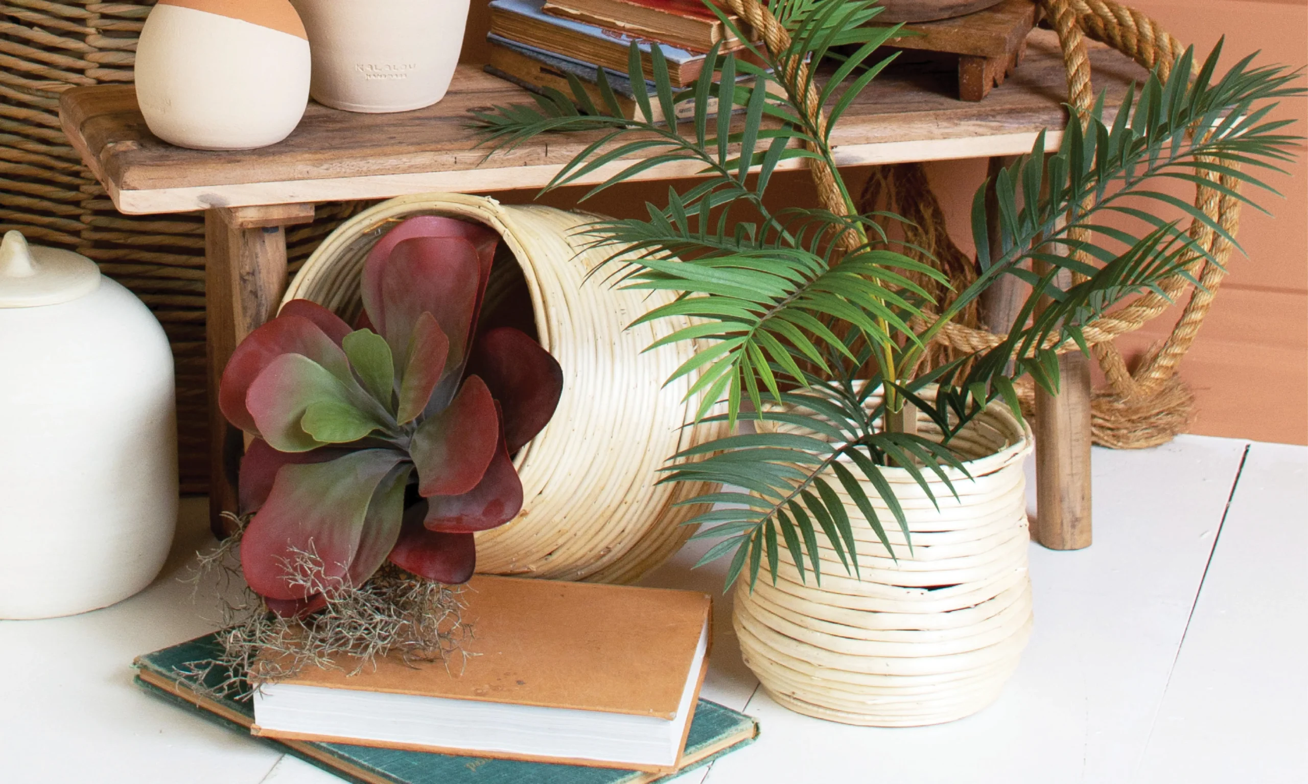 faux ferns and succulents with bamboo baskets and rustic risers.